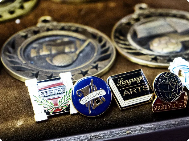 Service award medals and engraved lapel pins on display