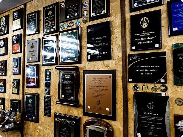 Wall of engraved plaques and awards in the Trophies Unlimited shop