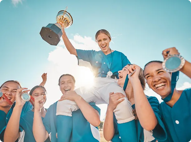 Team celebrating together and holding up a trophy